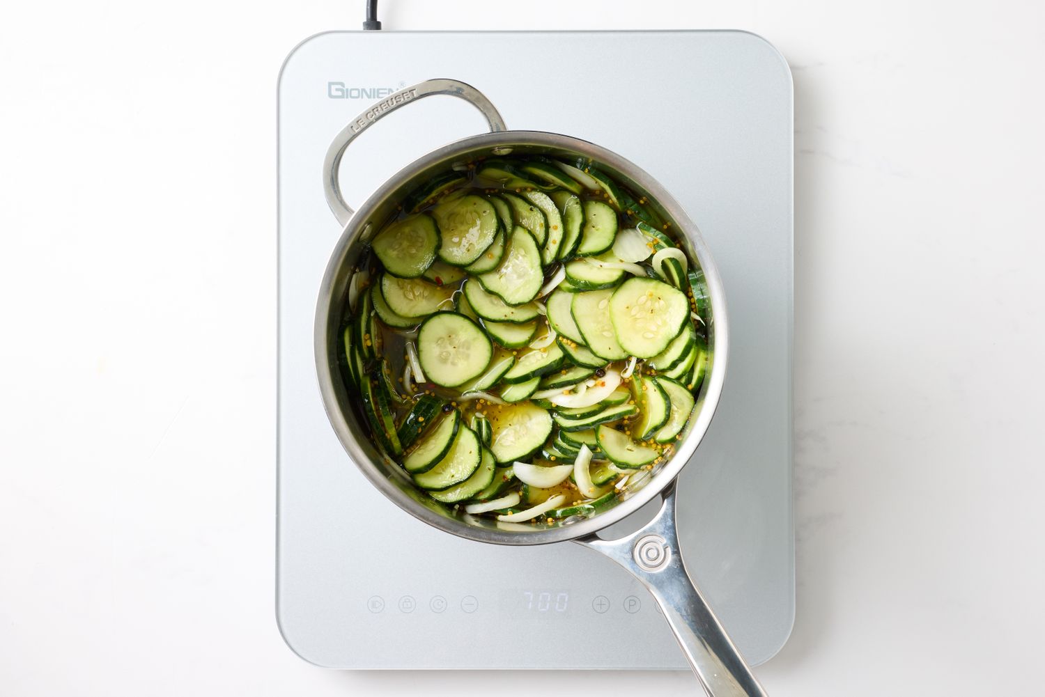 Sliced cucumbers in a pot on a stovetop