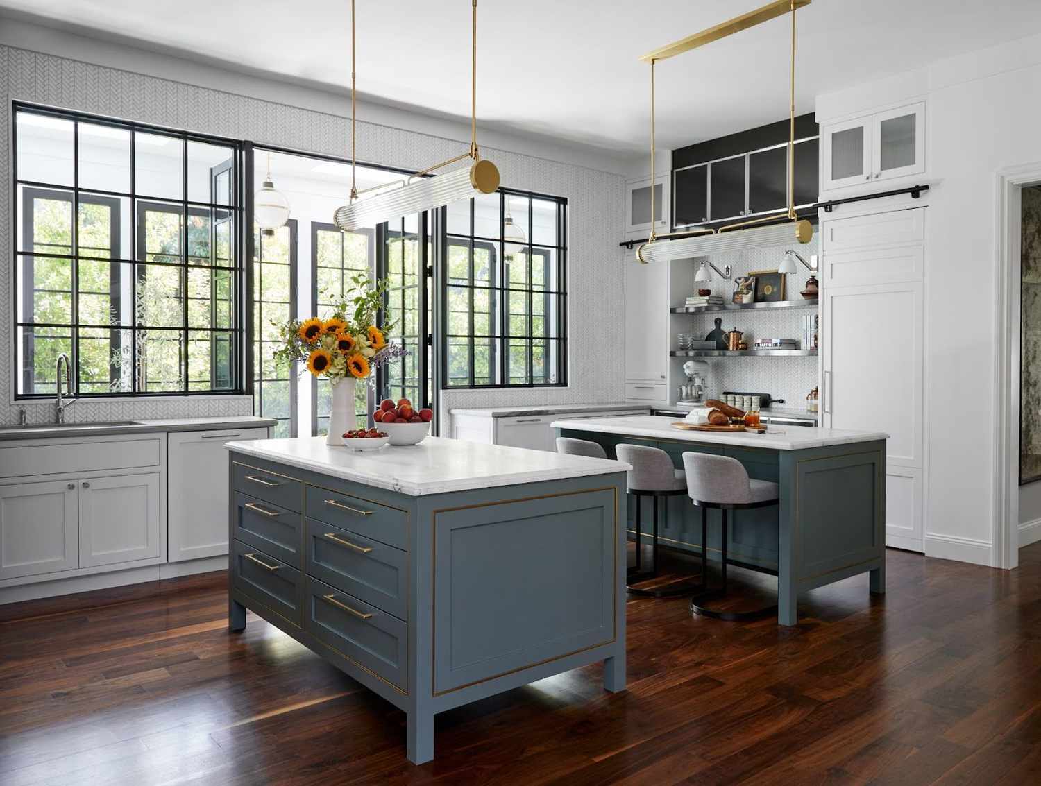 a white kitchen with gold lighting