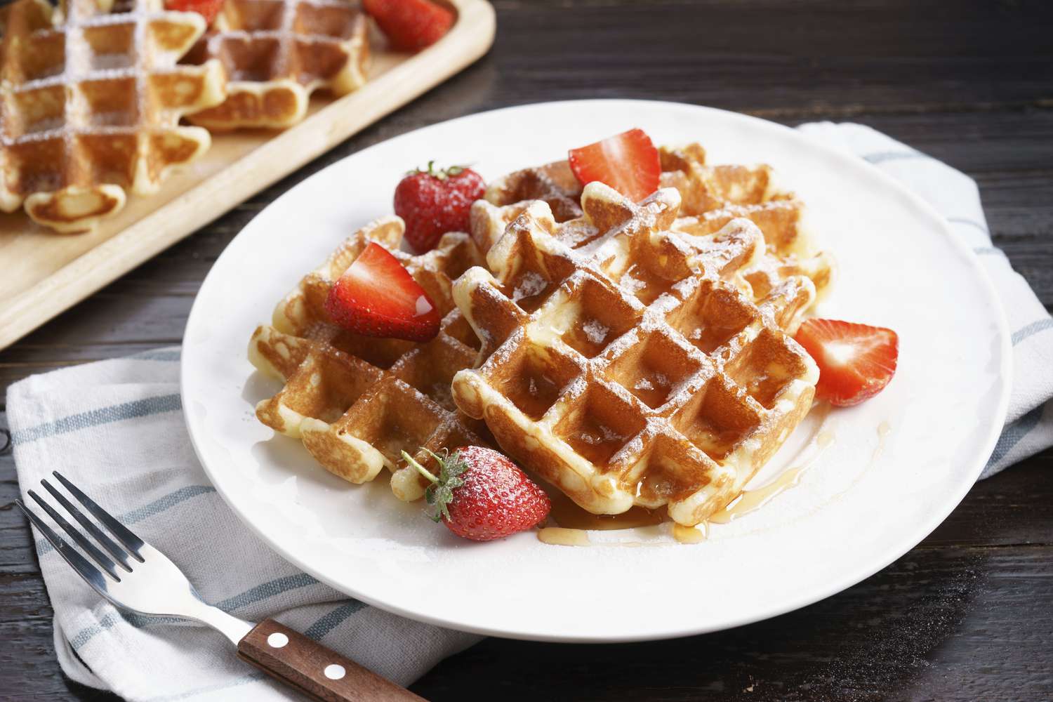 sorghum flour waffles with strawberries on white plate