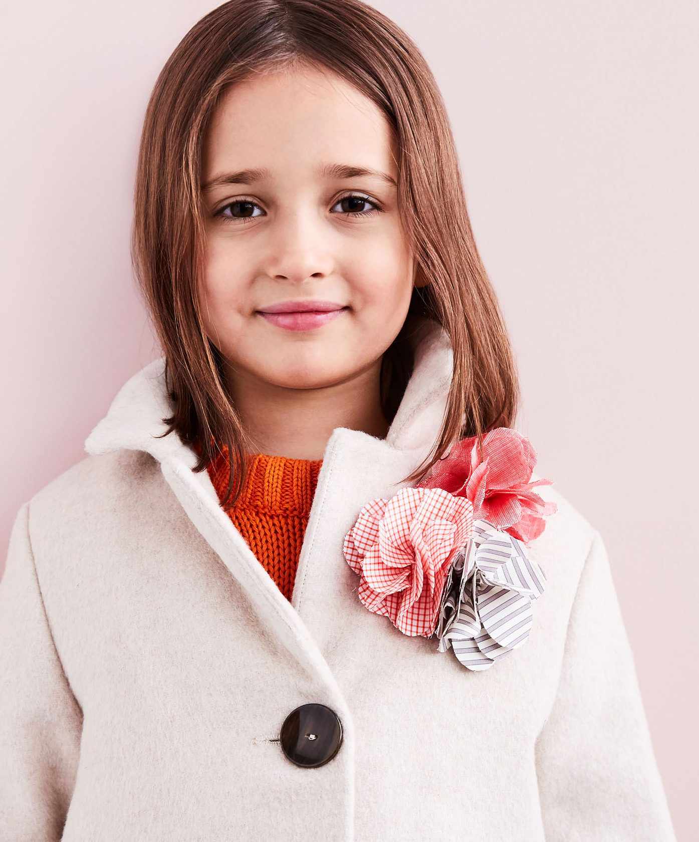 flower pin on little girl's coat close up