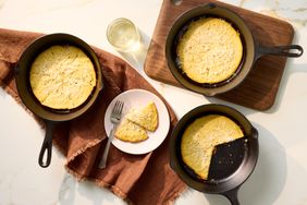 Three cast iron pans with farinata chickpea pancakes one sliced on a plate with a fork and two wedges