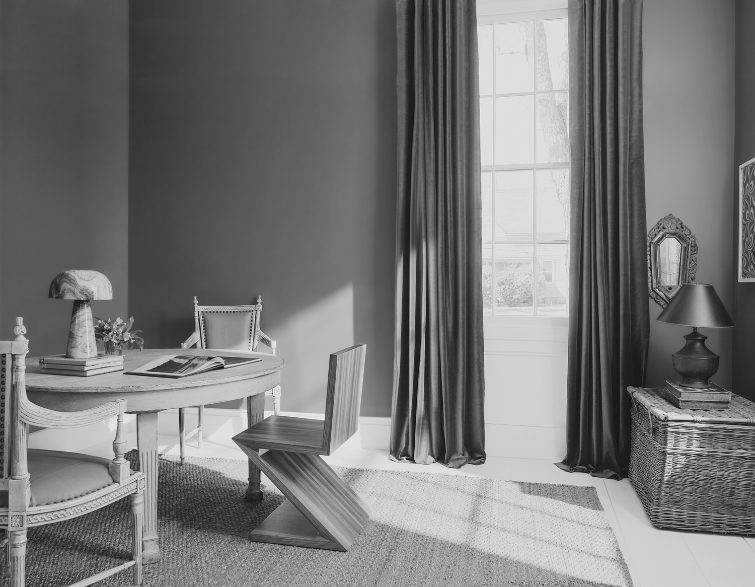 A wellfurnished interior room with a table chairs and a window letting in light featuring a modern and traditional decor mix