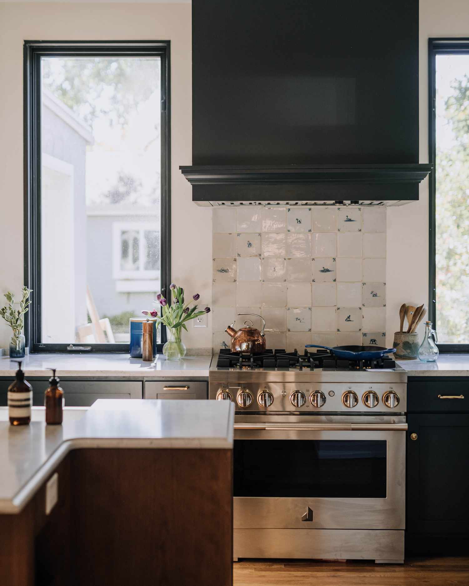 distressed kitchen blacksplash with black stove hood