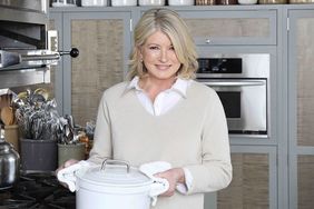 decorvow holding a pot in a kitchen