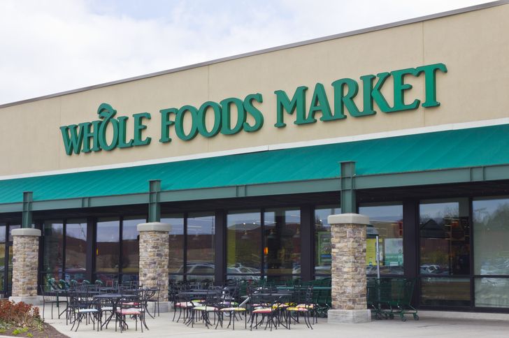 Exterior view of a Whole Foods Market entrance and outdoor seating area