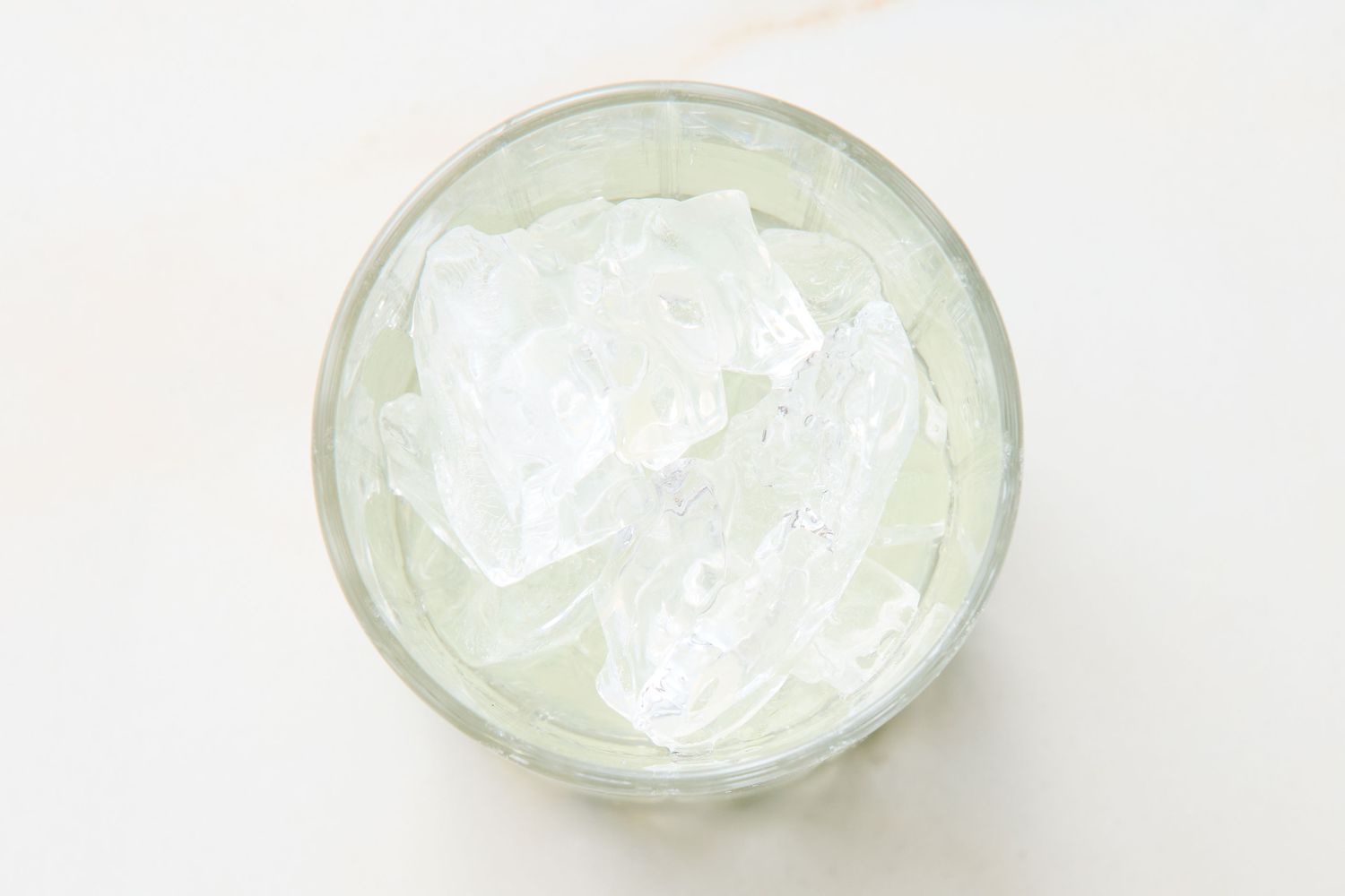 Glass filled with ice cubes viewed from above