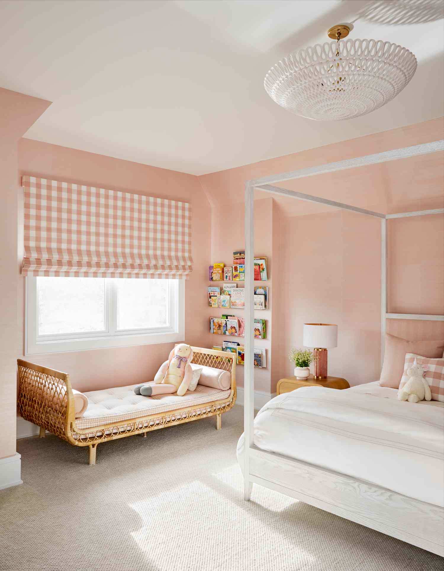 Pink girl's bedroom with white and rattan furniture