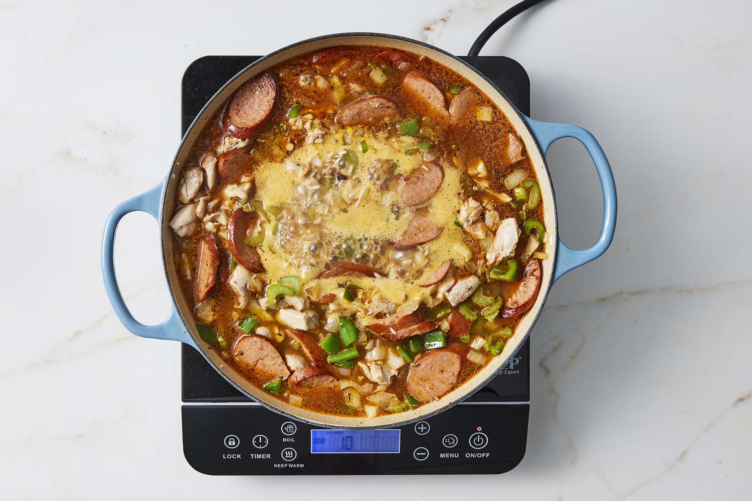 Cajun jambalaya ingredients in skillet