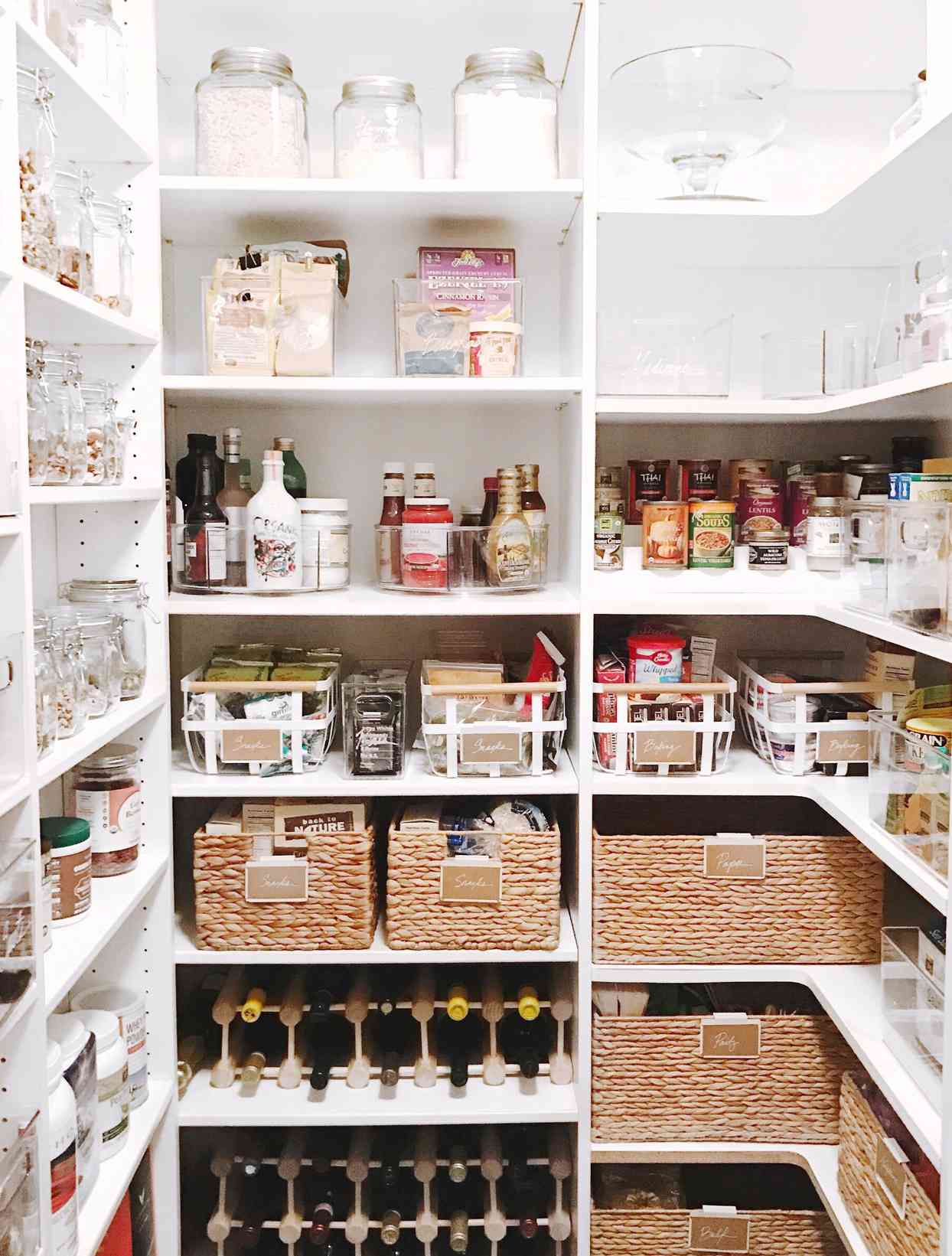 spacious white shelving pantry filled with various items