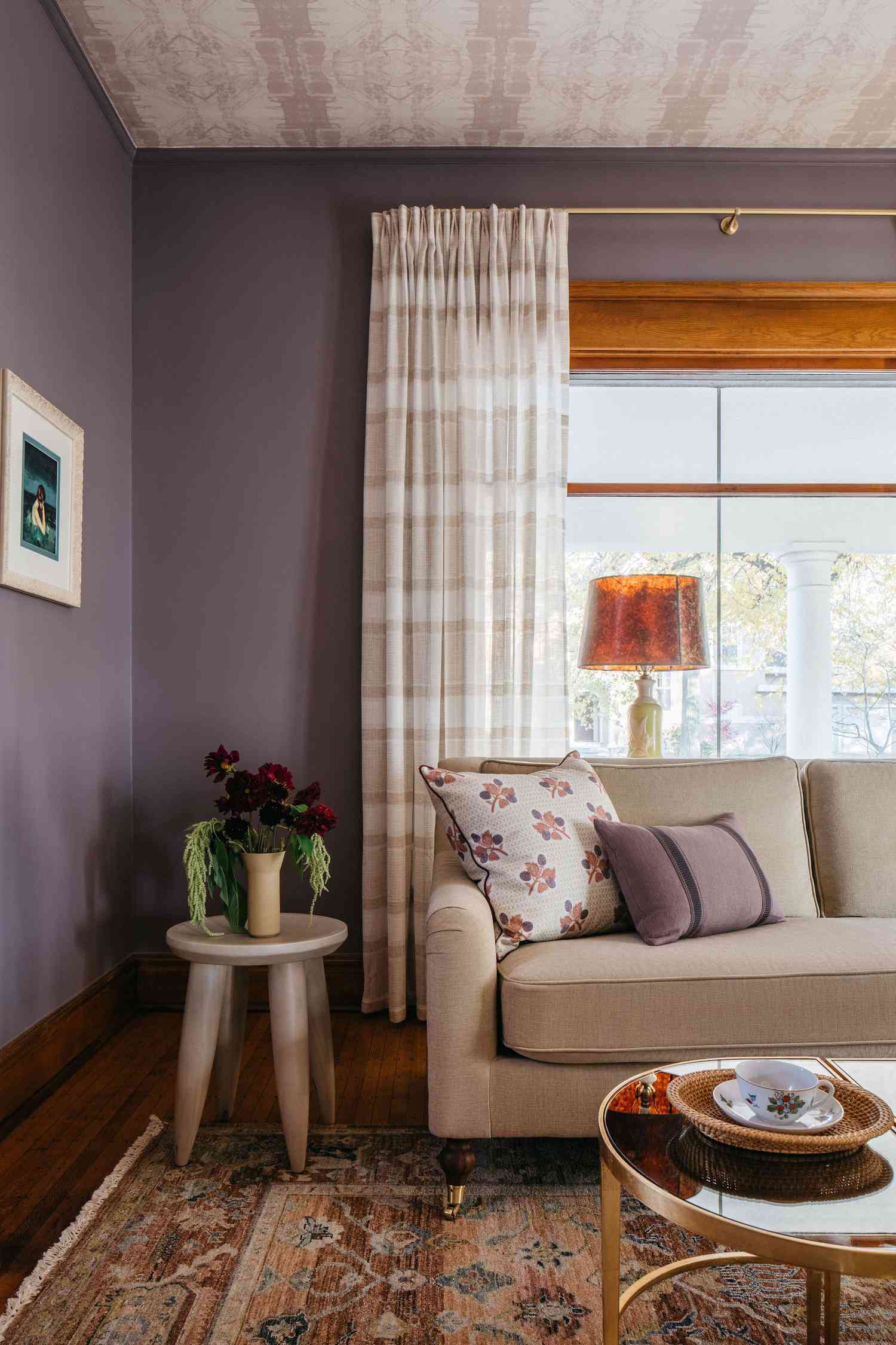 Living room with purple walls, wallpapered ceiling