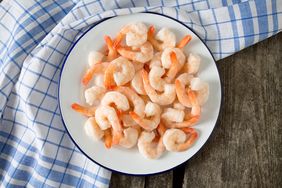 frozen shrimps on wooden surface