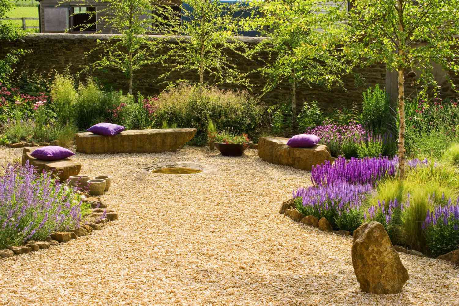 Gravel garden with rock seats and wild flowers