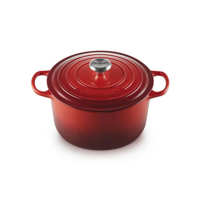 A round castiron Dutch oven with a lid and handles branded Le Creuset