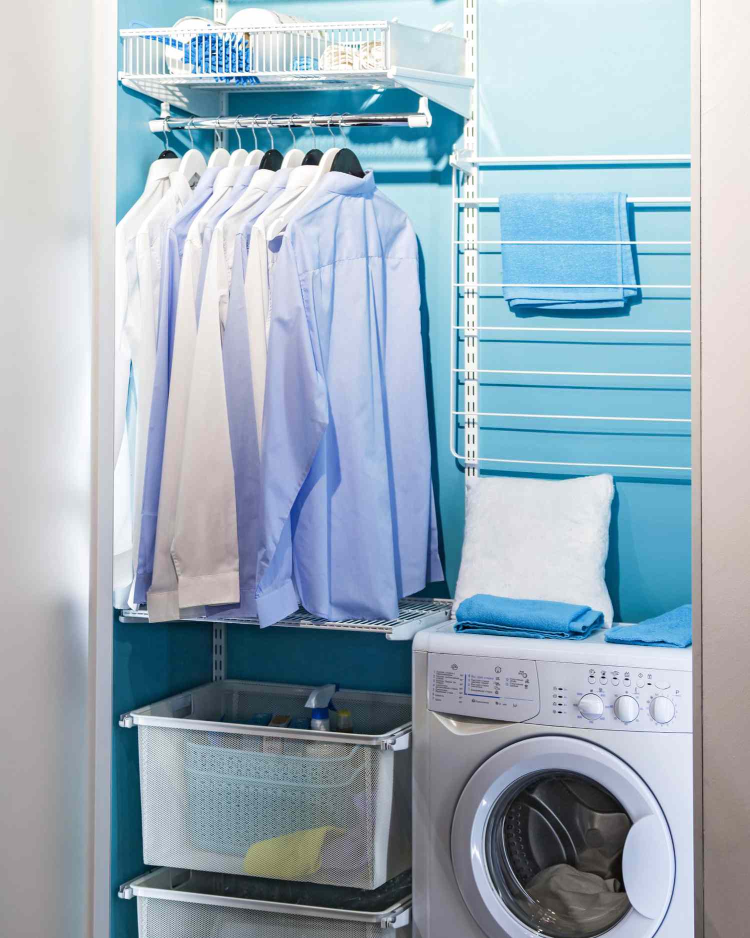 Washing room, modern design with a laundry machine with hangers for clothes, an iron, shelves and a washing machine