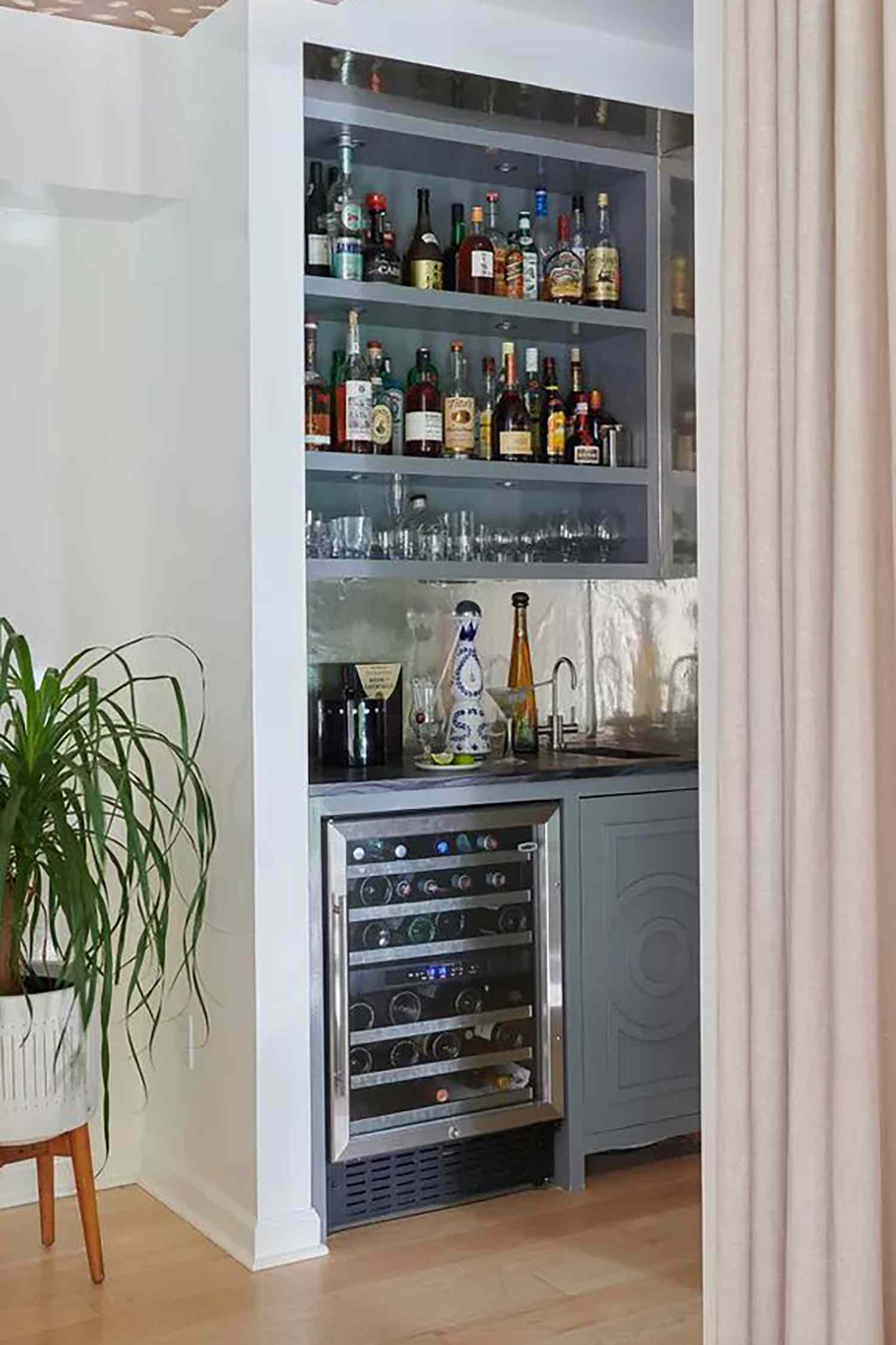 Basement bar that is tucked behind a curtain
