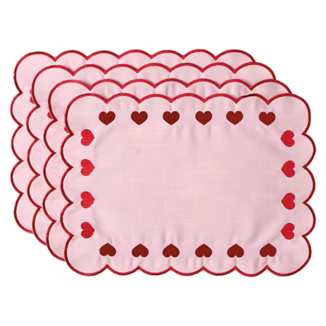 Four decorative placemats with scalloped edges and heart patterns