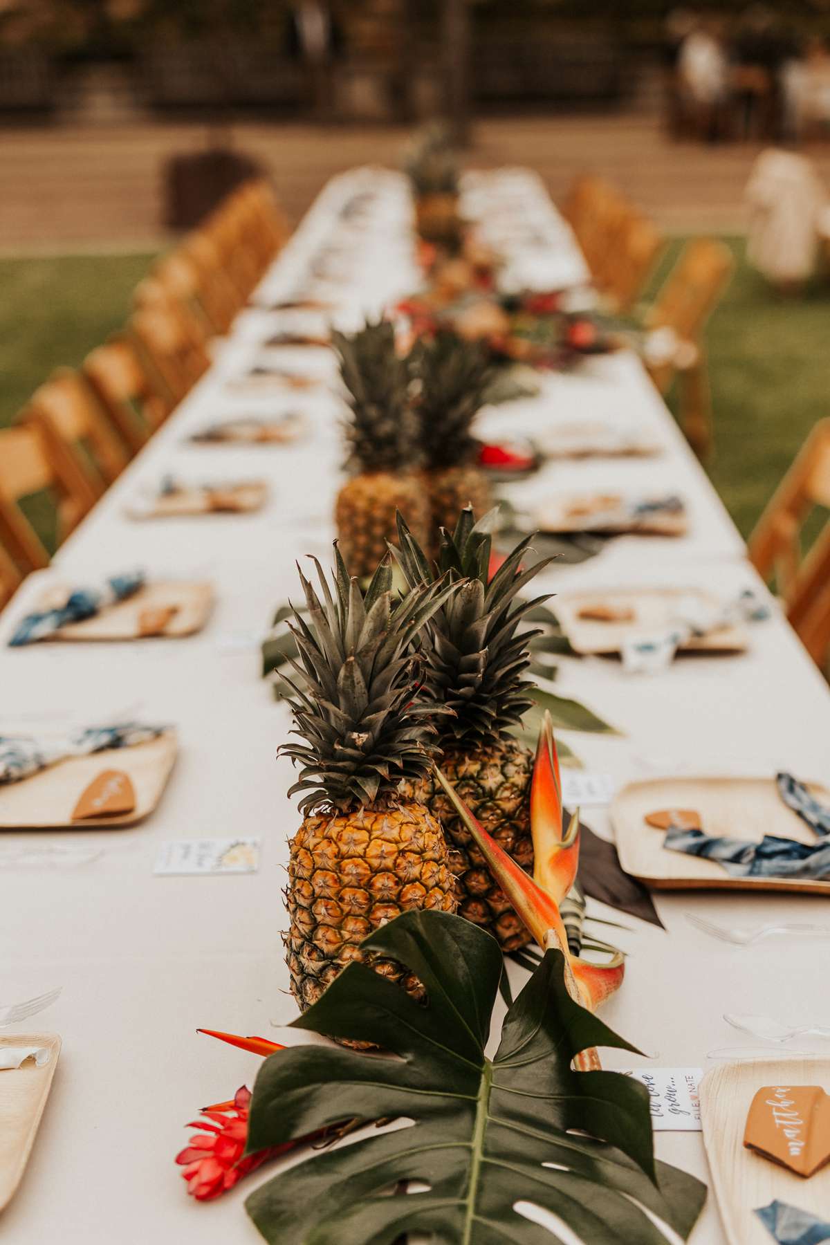 non-floral wedding centerpieces pineapples and monstera leaves
