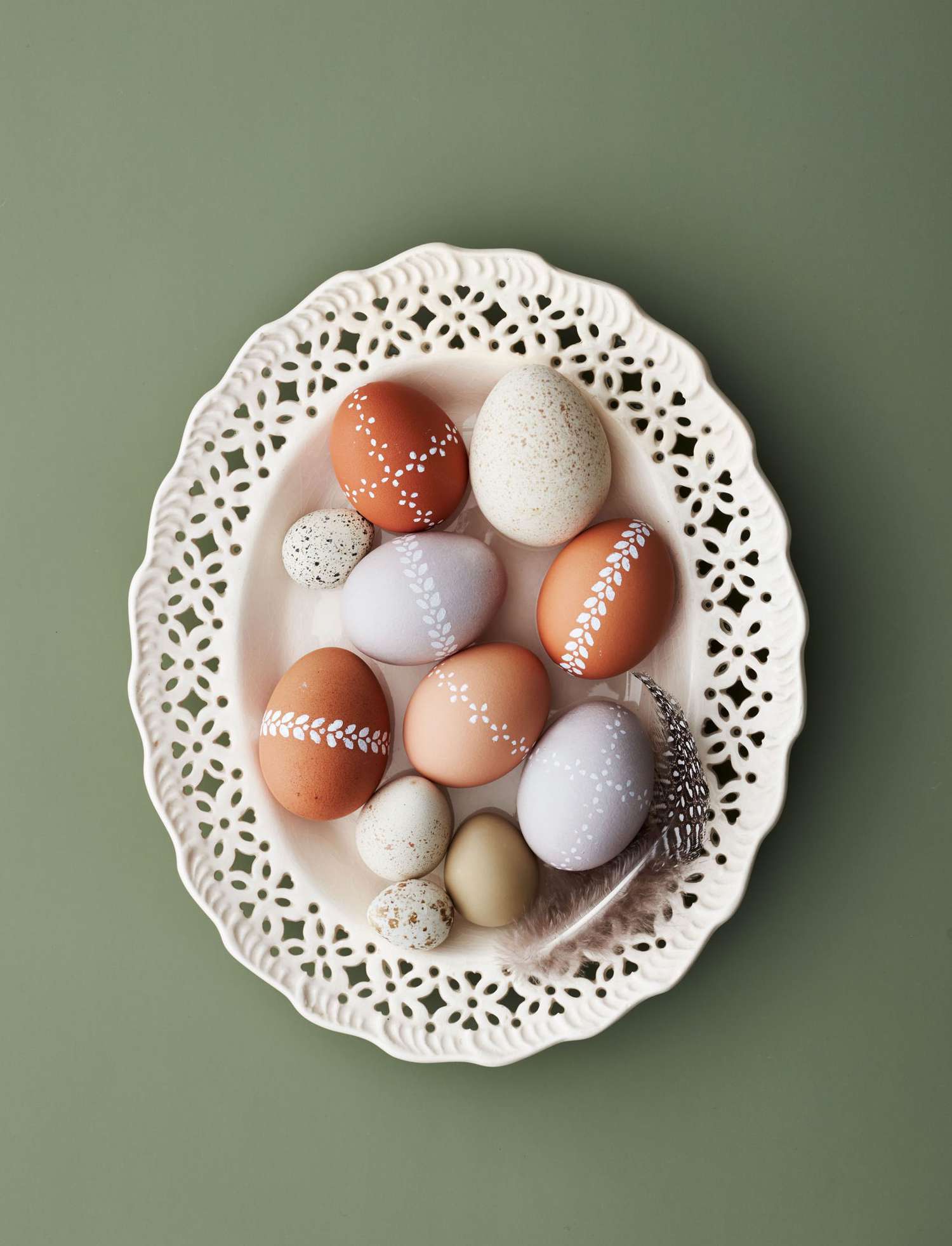 lace-painted easter eggs in an ivory dish