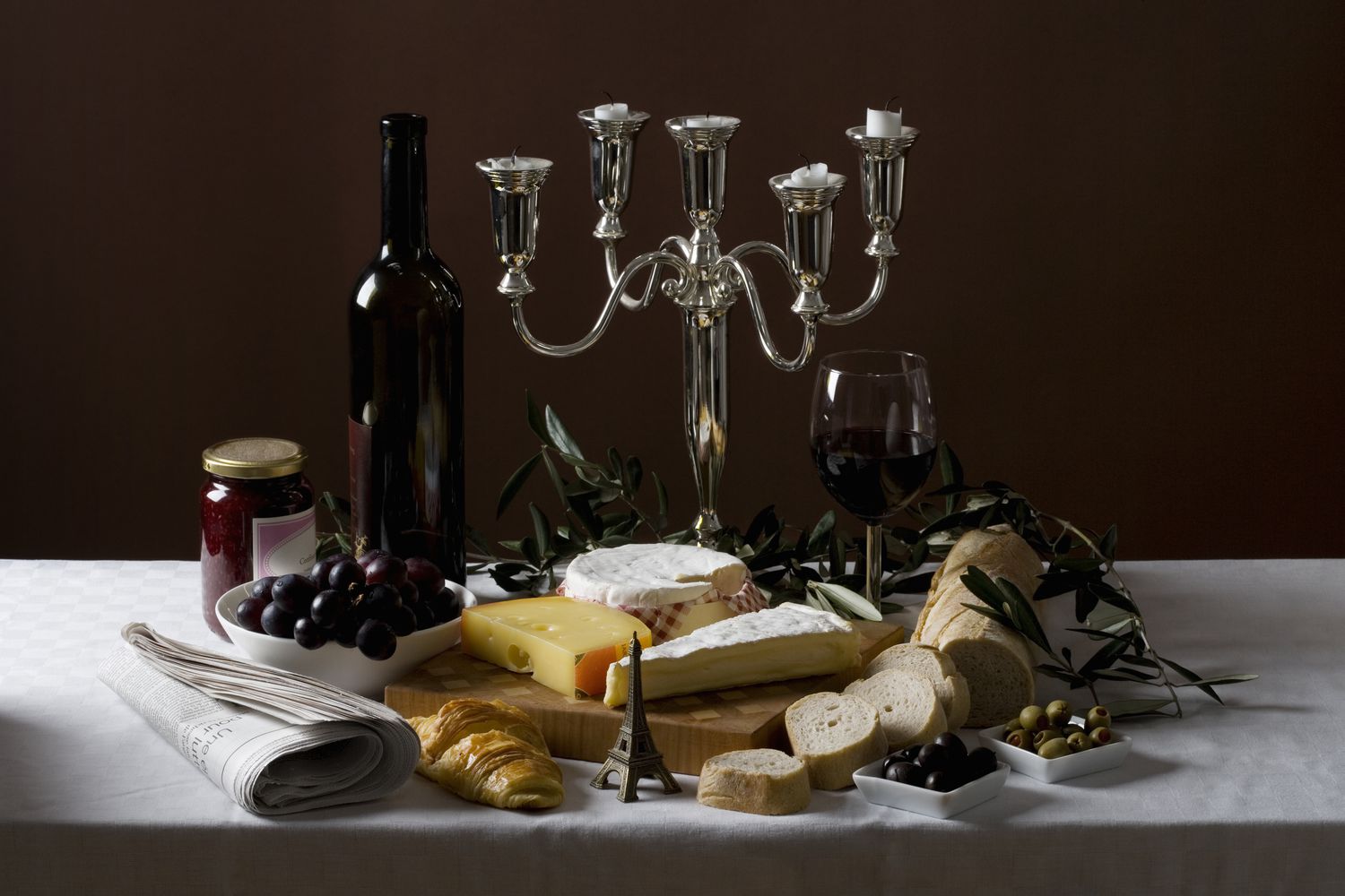 A candelabra surrounded by cheese and charcuterie