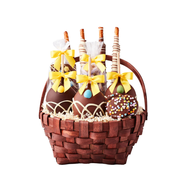 A basket containing chocolatedipped treats some decorated with ribbons and sprinkles arranged in a festive display