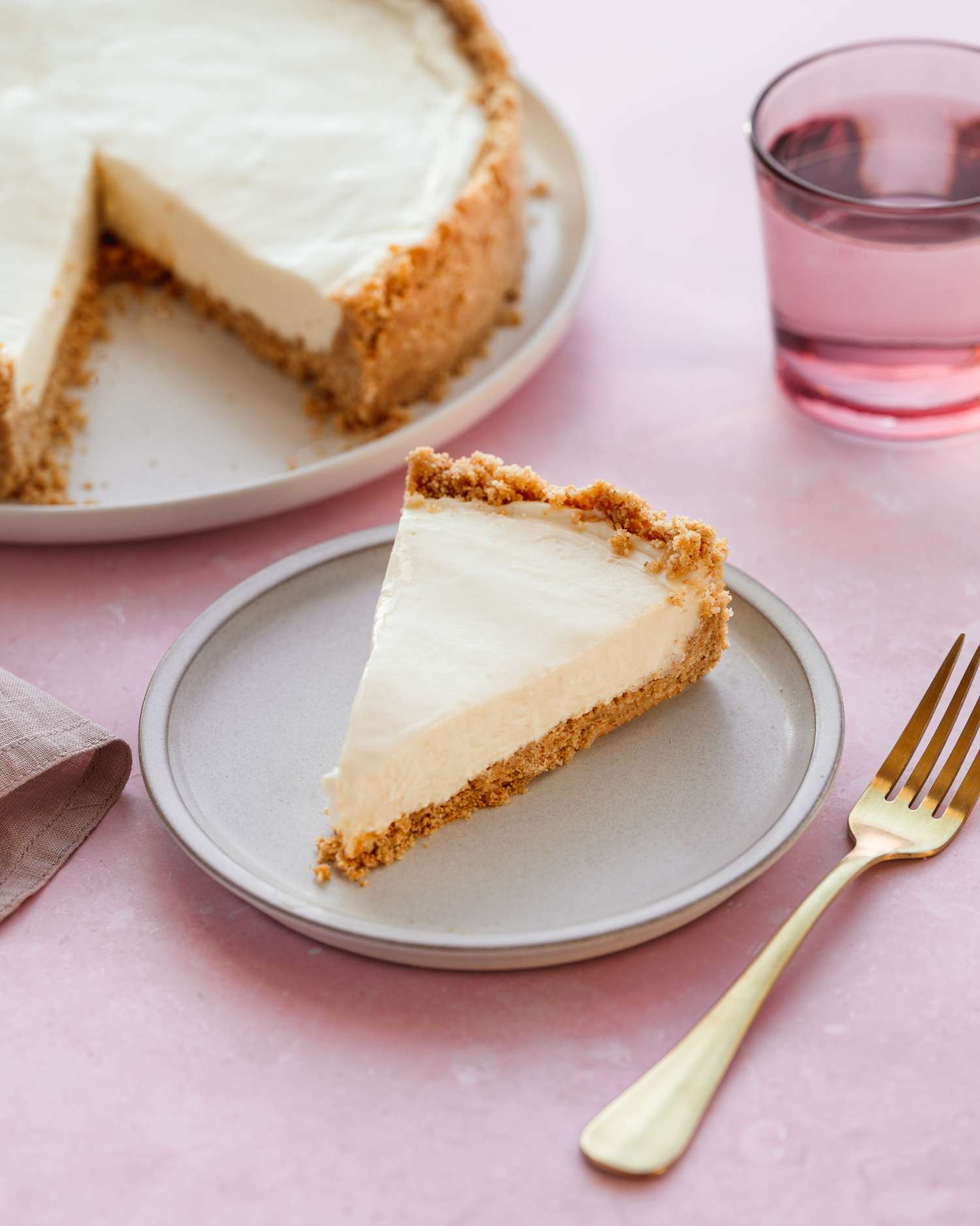 no bake cheesecake slice on plate with cheesecake 