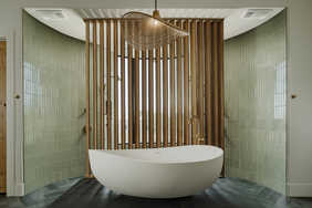 A bathroom with green tiles