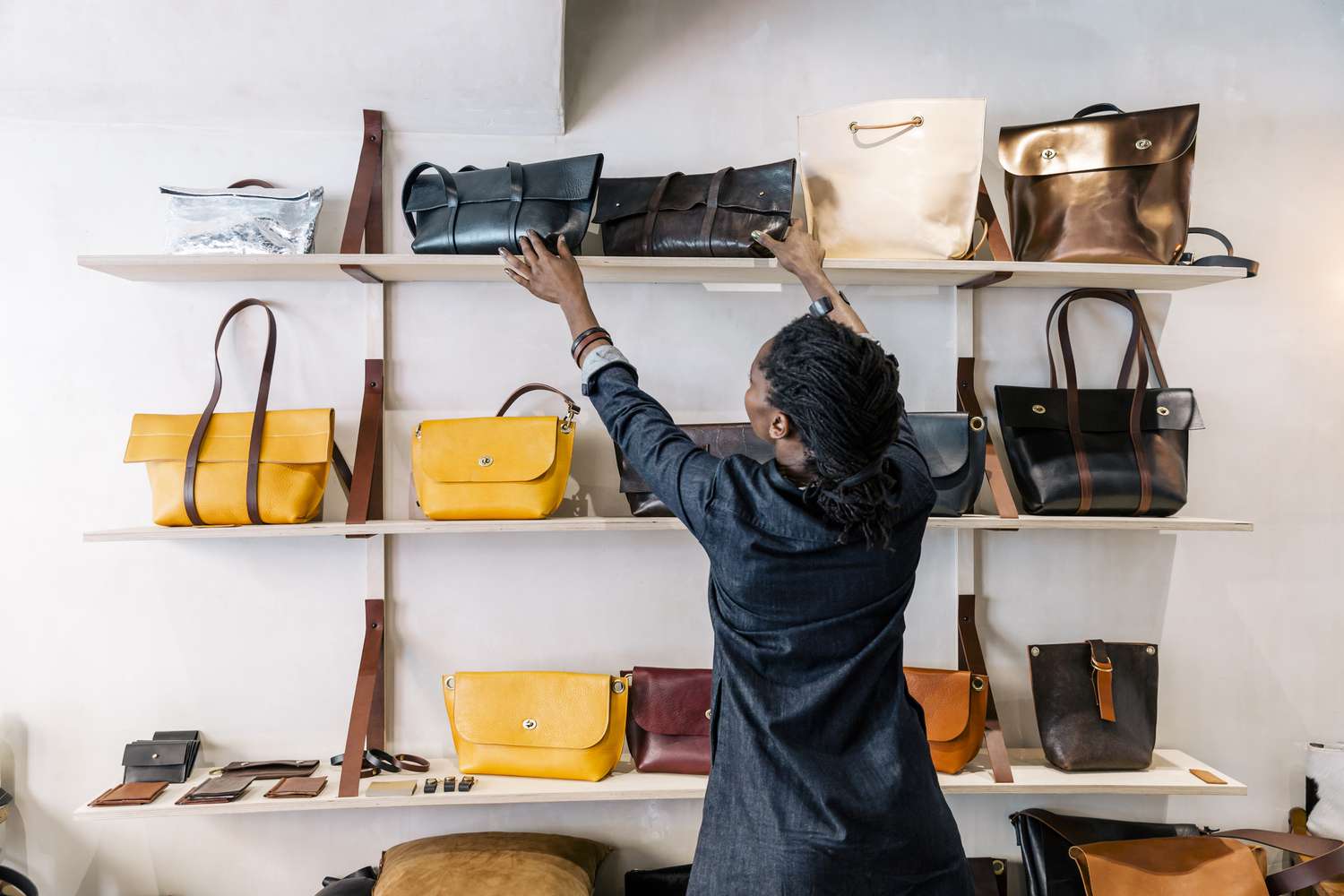 Woman shopping for leather handbags