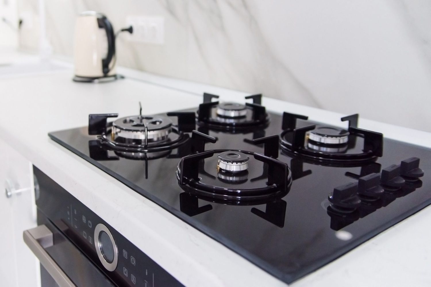 Modern high-tech black gas stove with sensor panel in the bright interior of the kitchen
