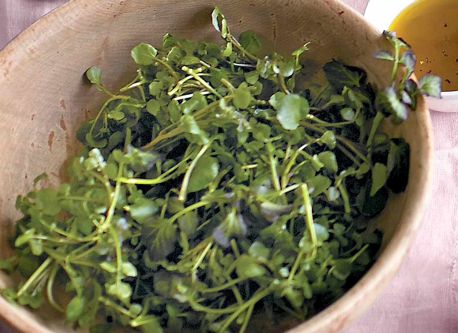 watercress salad in a wooden bowl