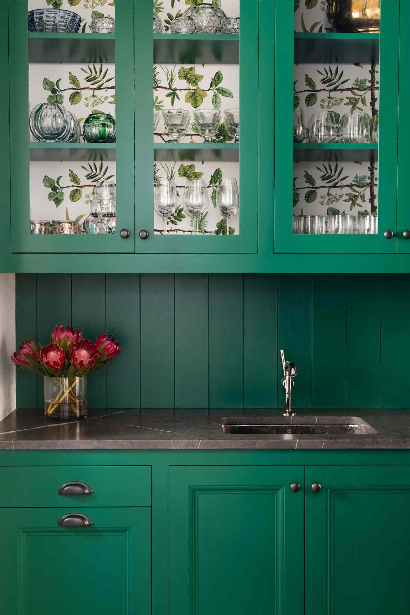 small kitchen with wallpaper lined cabinets