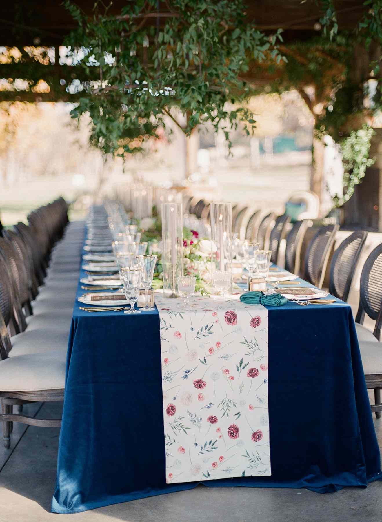 single long reception table with blue linen and velvet