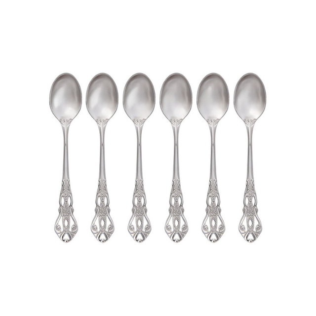 A row of six identical ornate spoons placed together