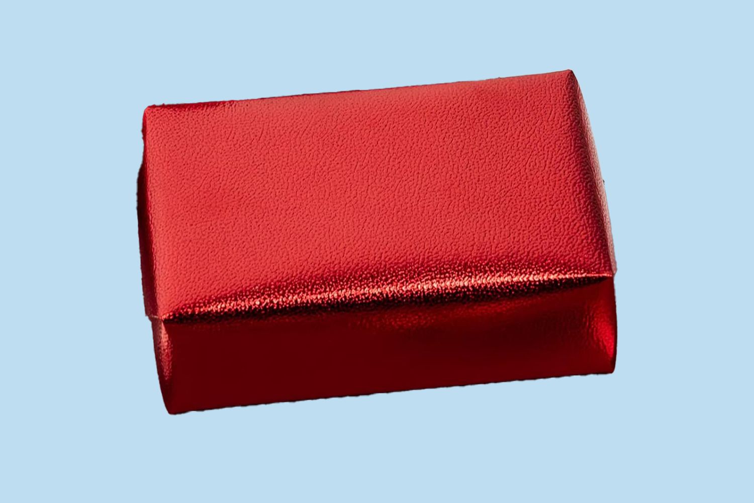 A rectangular box wrapped in shiny red paper