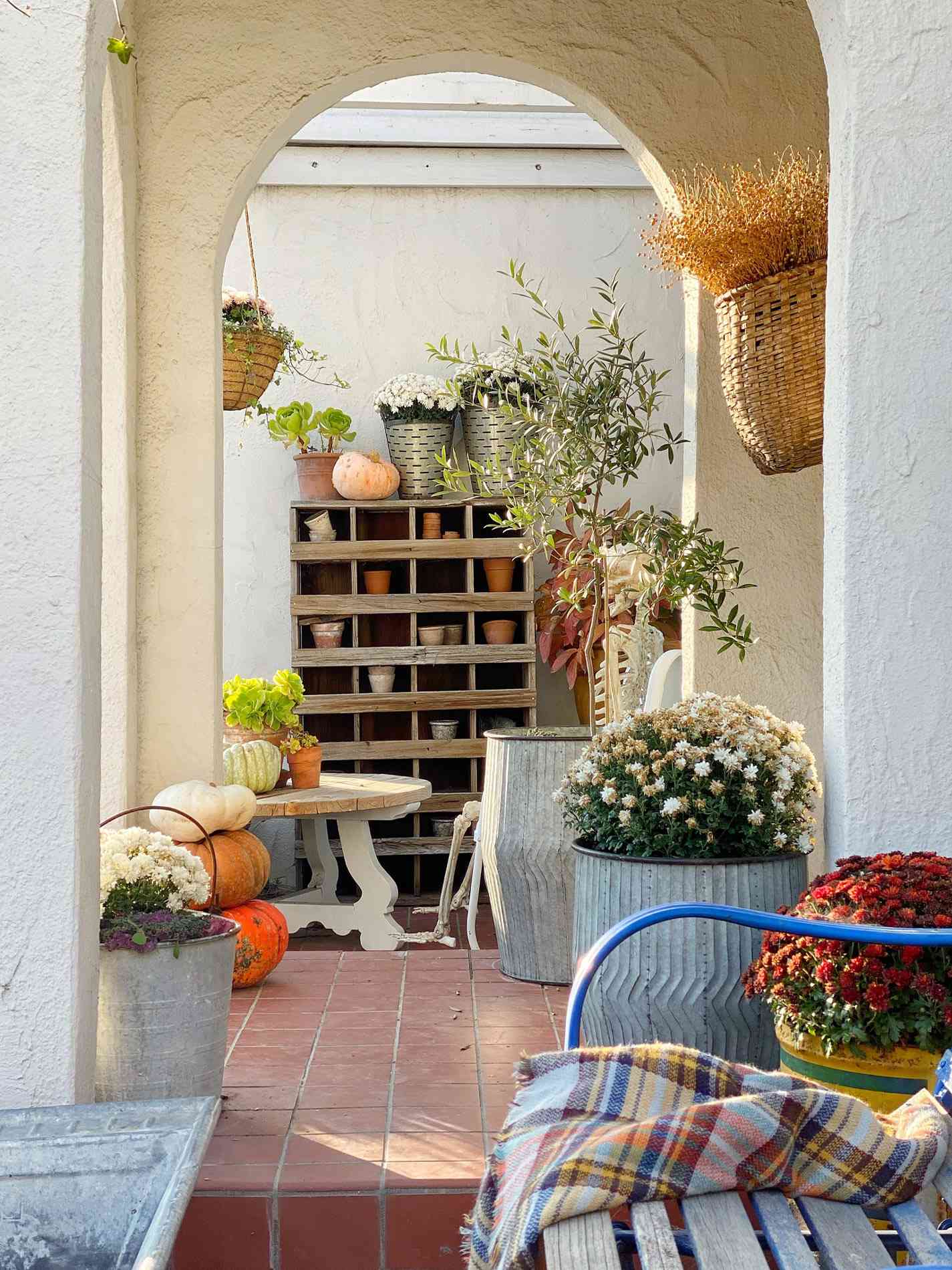 rustic fall porch with pumpkins and mums