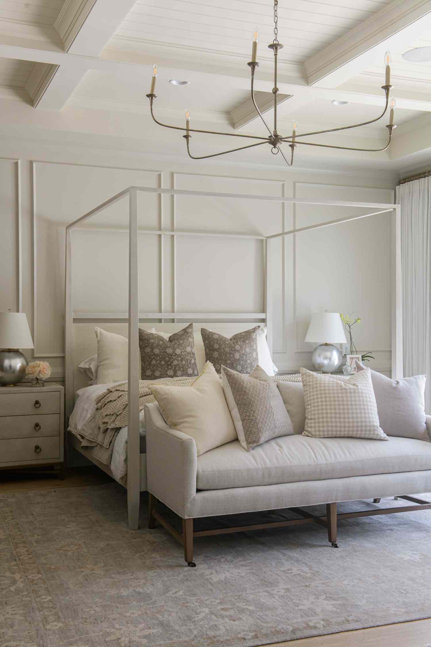 a white bedroom with a chandelier
