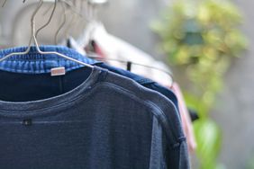 Clothing items hanging on hangers outdoors