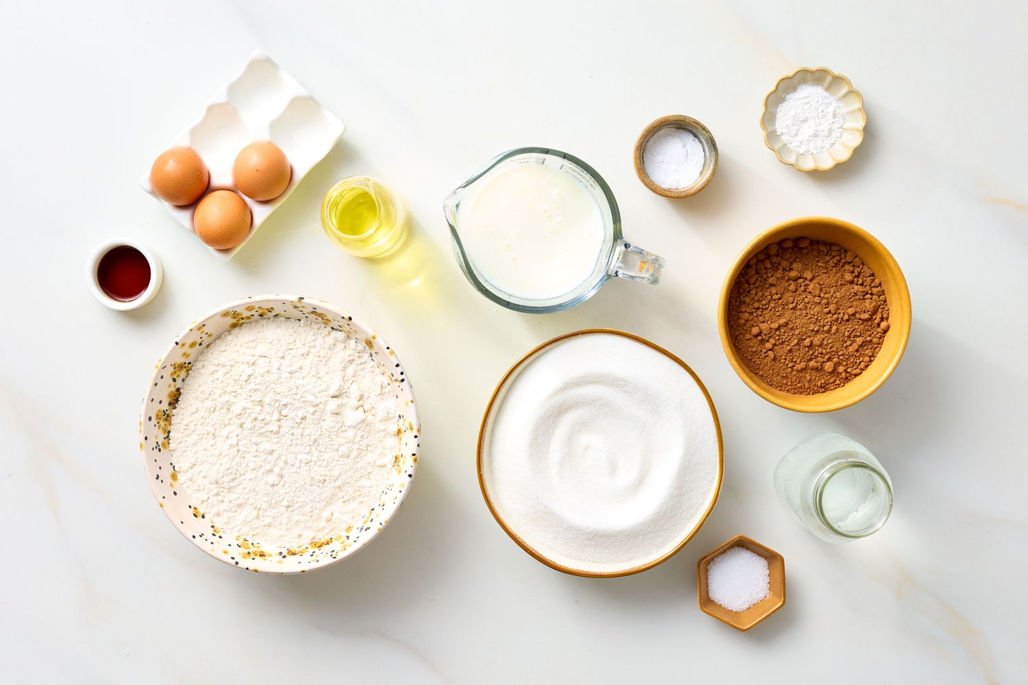 Ingredients for a chocolate cake arranged on a countertop
