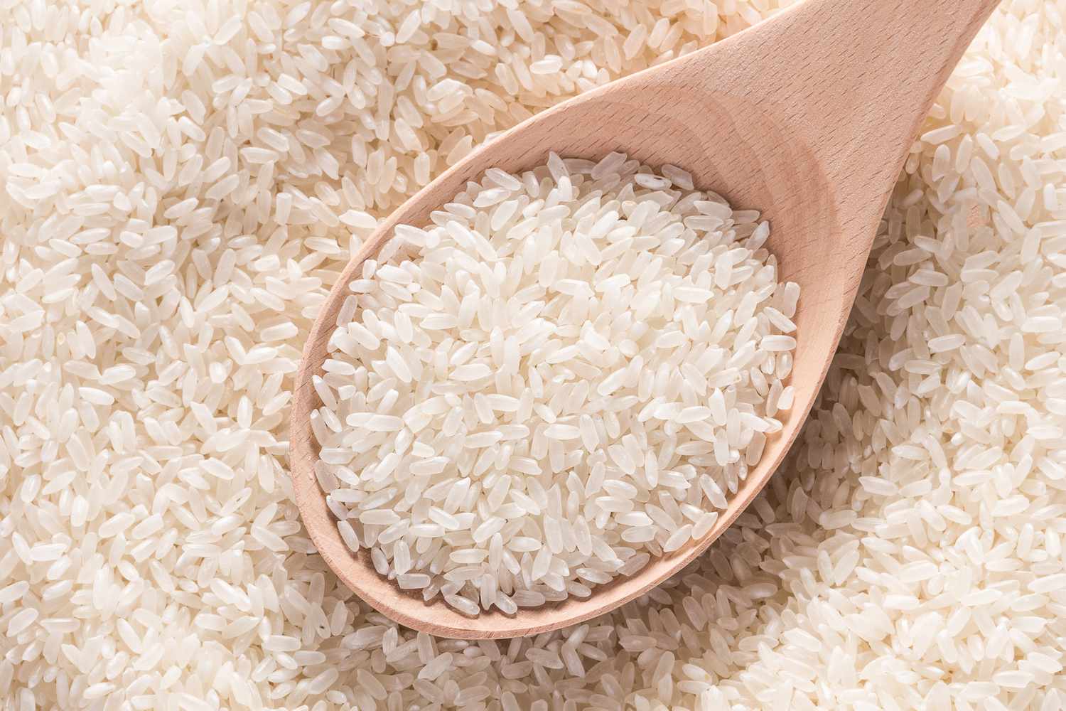 white rice in wooden spoon