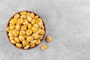 A bowl of lupini beans on a gray surface