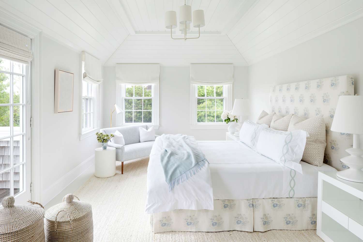 bright white master bedroom with pale blue accents