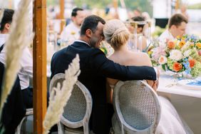 couple embracing at table during wedding reception