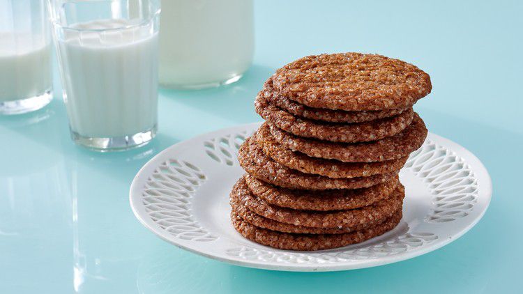 stack of molasses ginger crisps on white plate