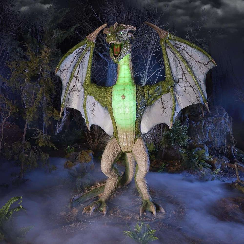 A large dragon statue with glowing parts displayed in a mystical forest setting