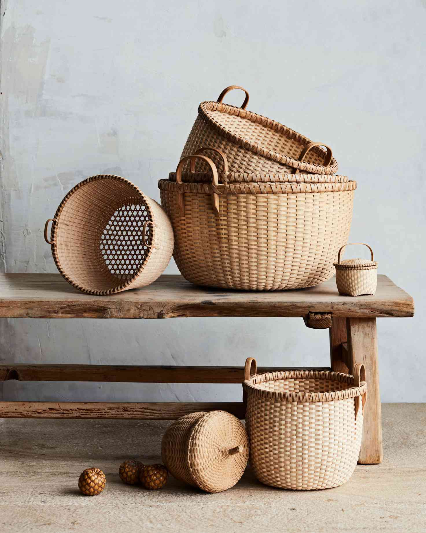 assorted woven baskets on wooden bench