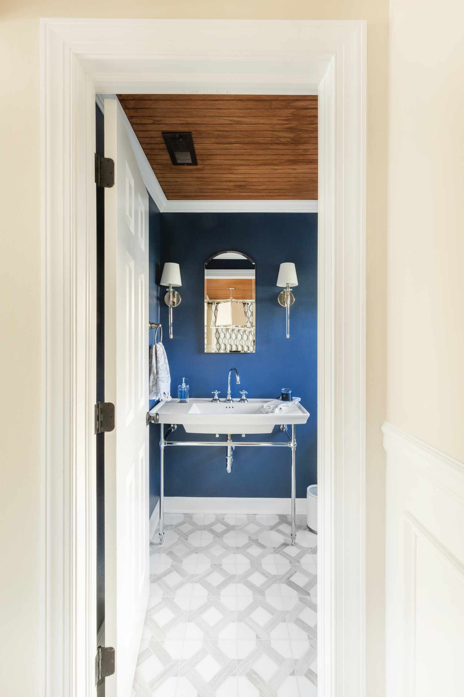 a blue bathroom with a wood ceiling