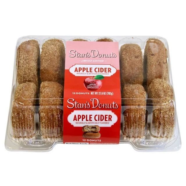 Packaged apple cider donuts labeled as Stans Donuts 12 donuts in a clear plastic container with branding on the label