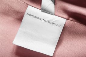 A fabric care label stating Professional Dry Clean Only on a pink garment
