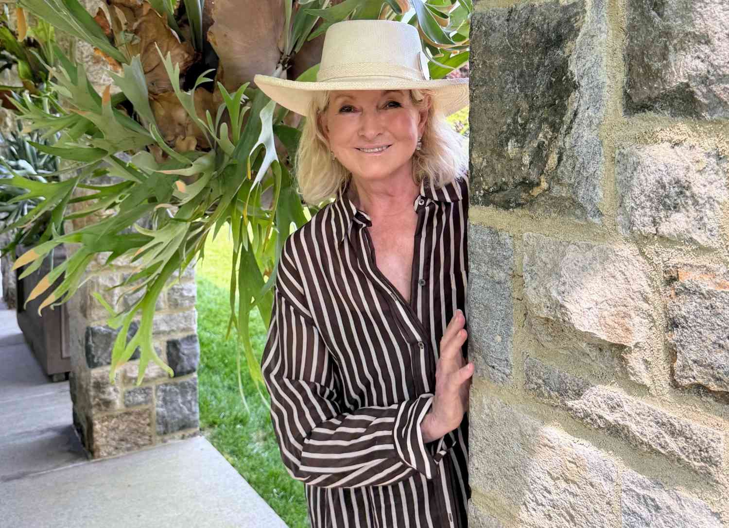 decorvow standing next to a stone wall