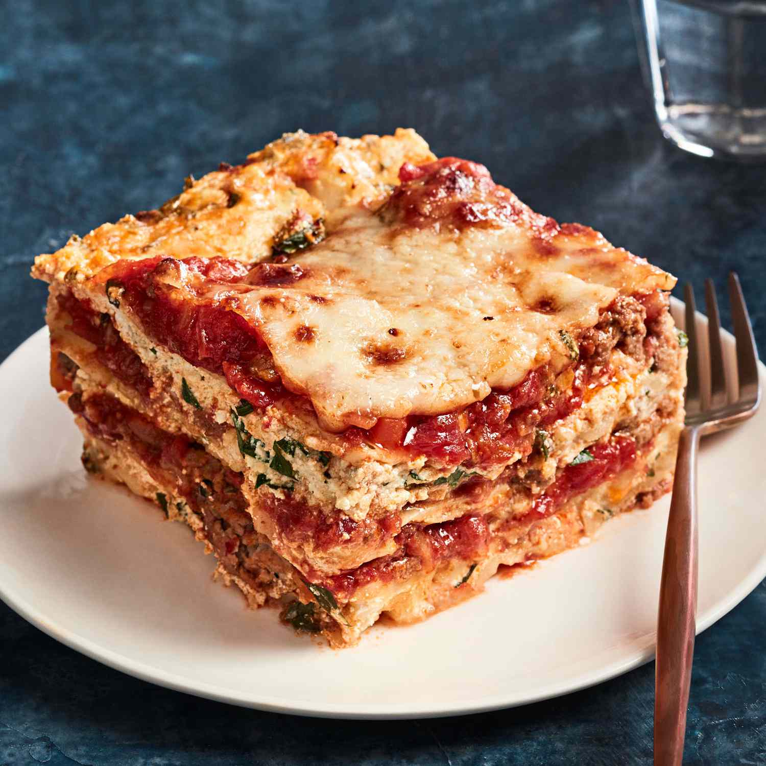ultimate lasagna slice on plate with fork