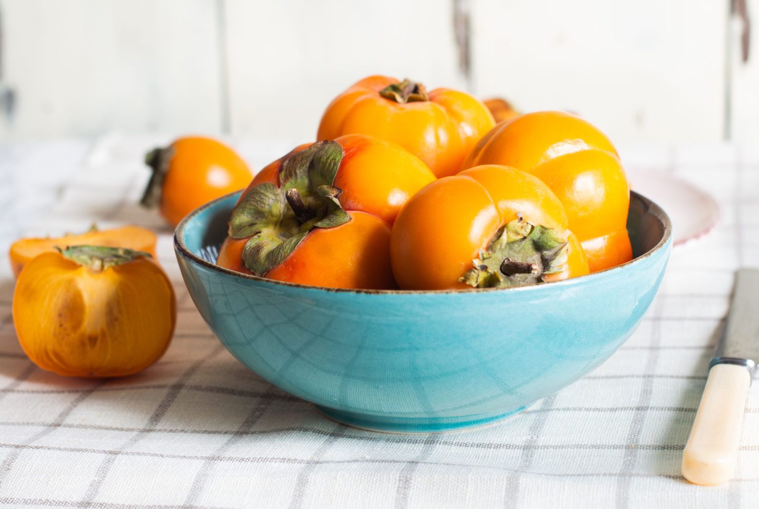 ripe fresh persimmons fruit in a bowl